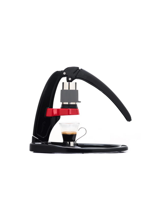 flair espresso machine in black and red with an espresso brewed into a glass cup